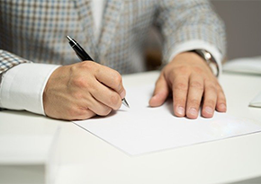 man signing document