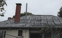 Image of a house, zoomed in on the roof.