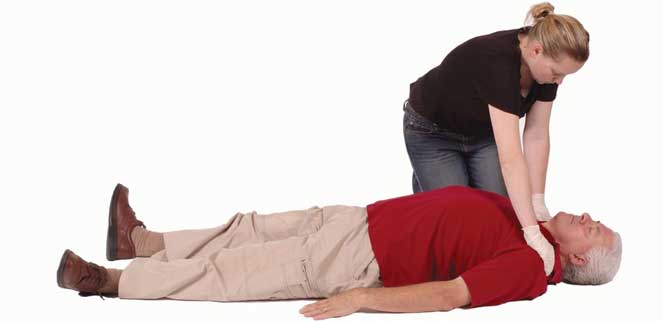 Woman squeezing shoulders of apparently unconscious man.