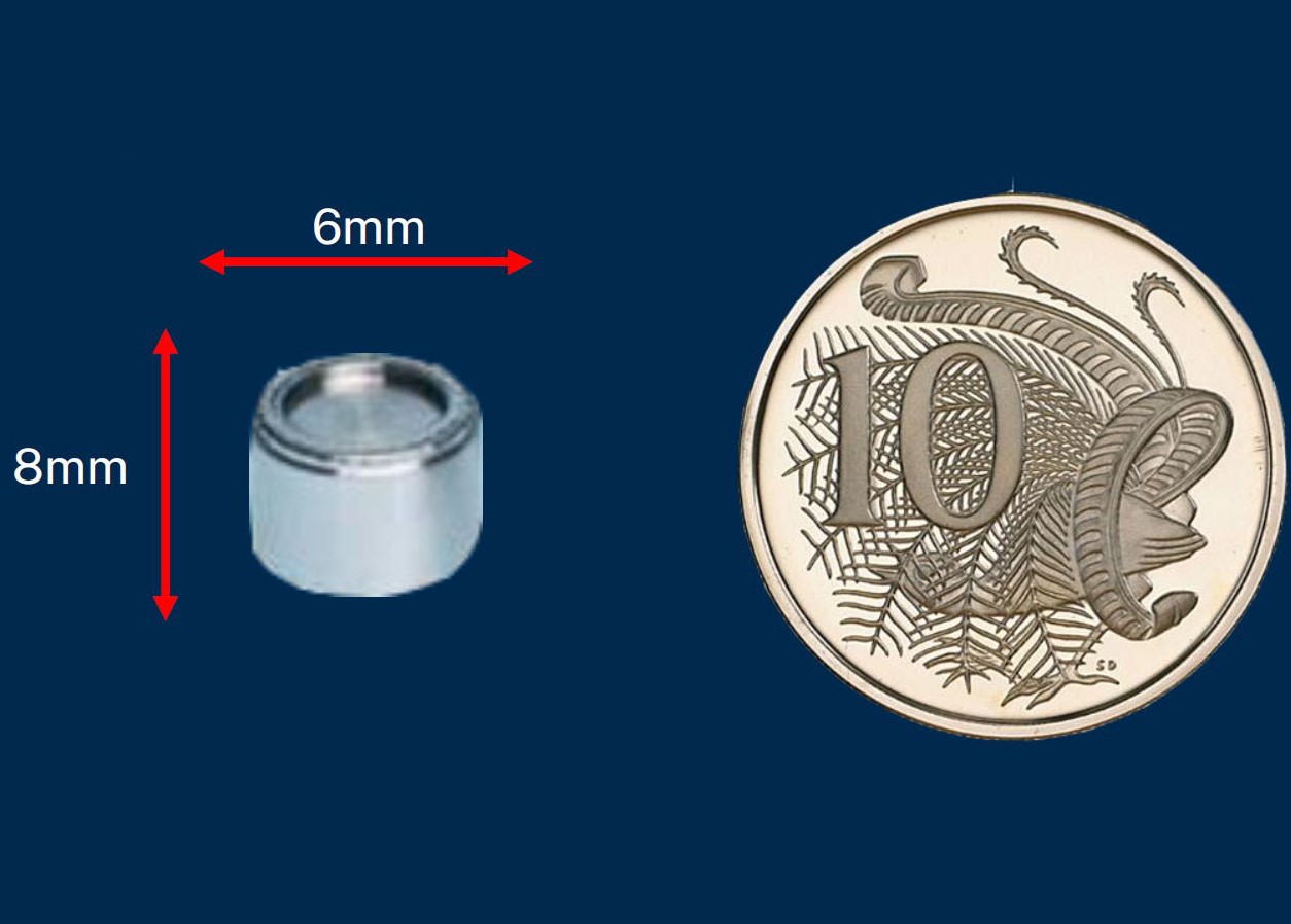 Caesium capsule next to Australian 10 cent piece as a size comparison
